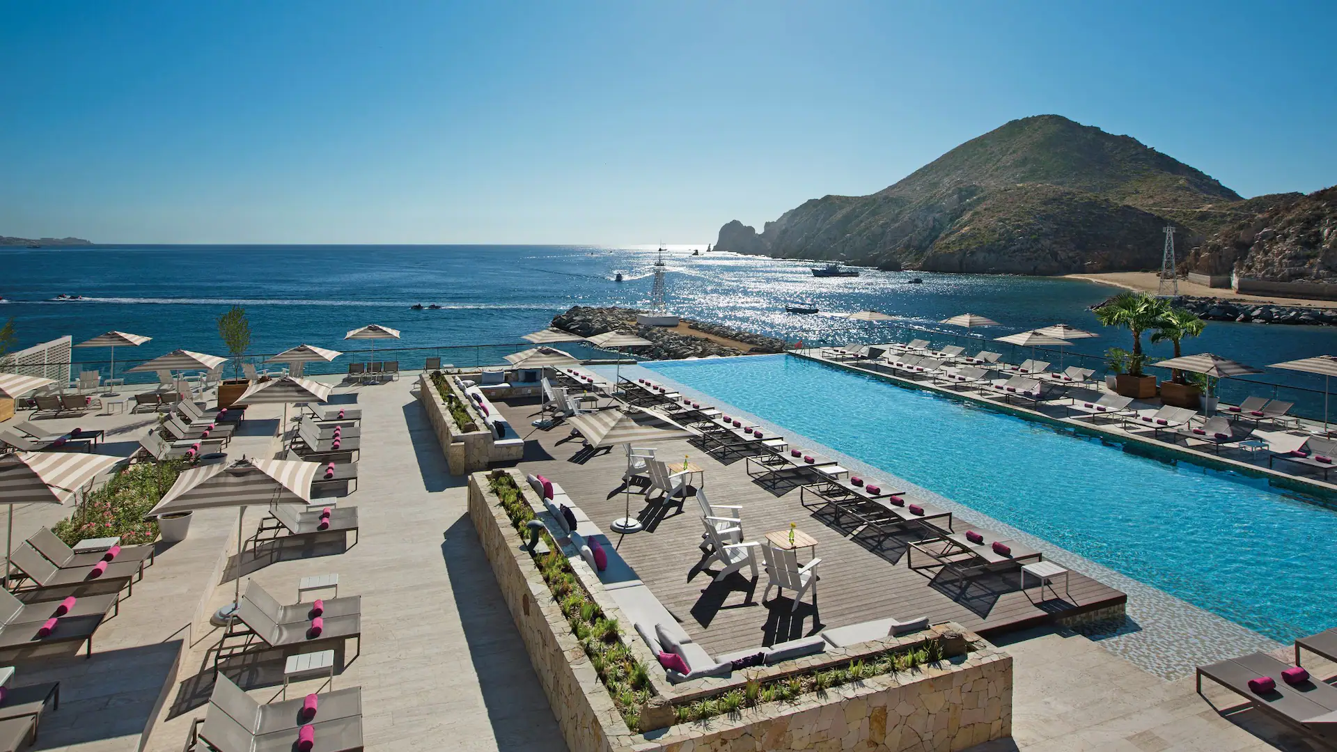 Breathless Cabo San Lucas adults-only resort overlooking the marina with lively pool and nightlife atmosphere.