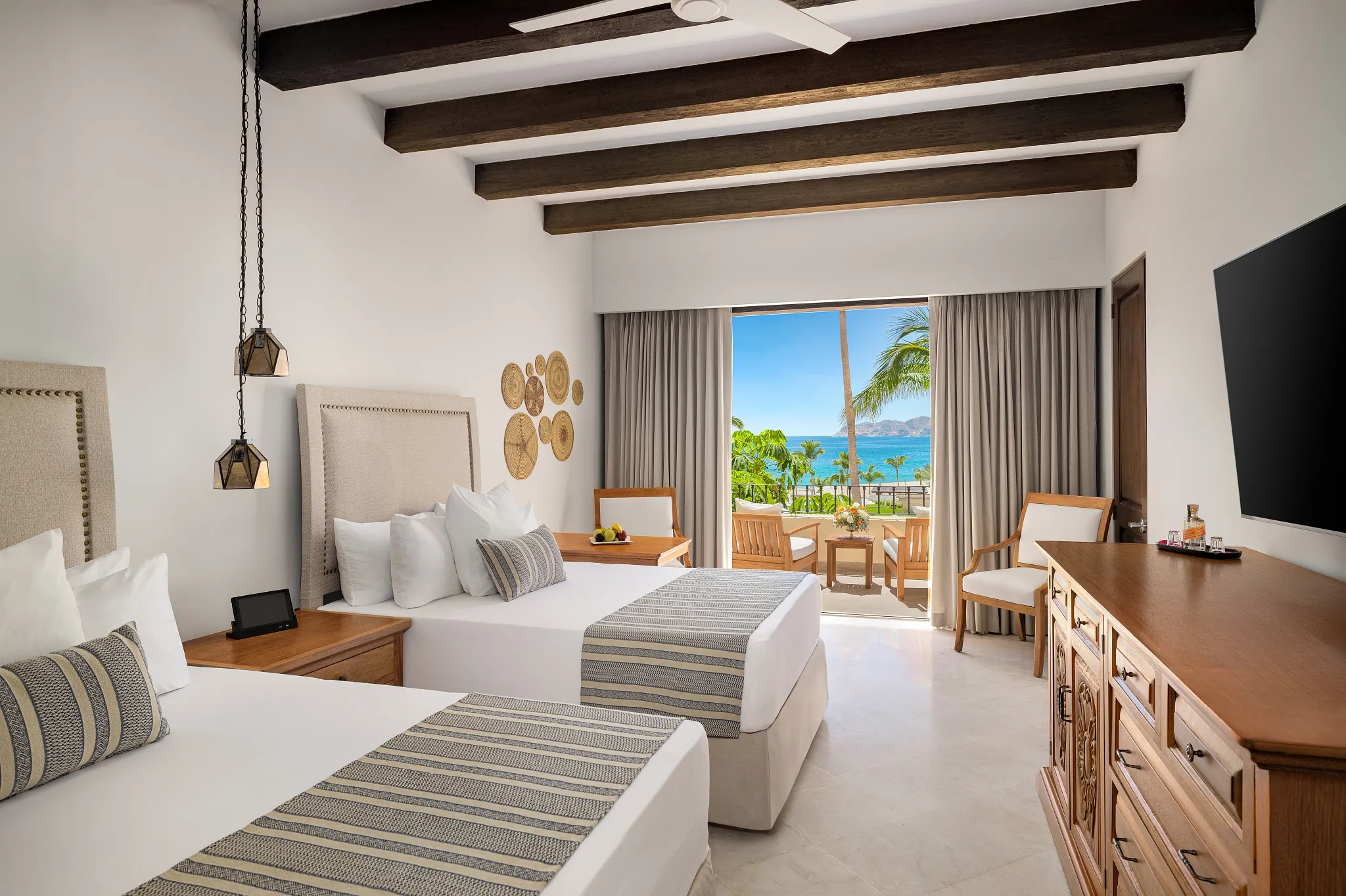 Deluxe Partial Ocean View room with two double beds at Zoëtry Casa del Mar Los Cabos.