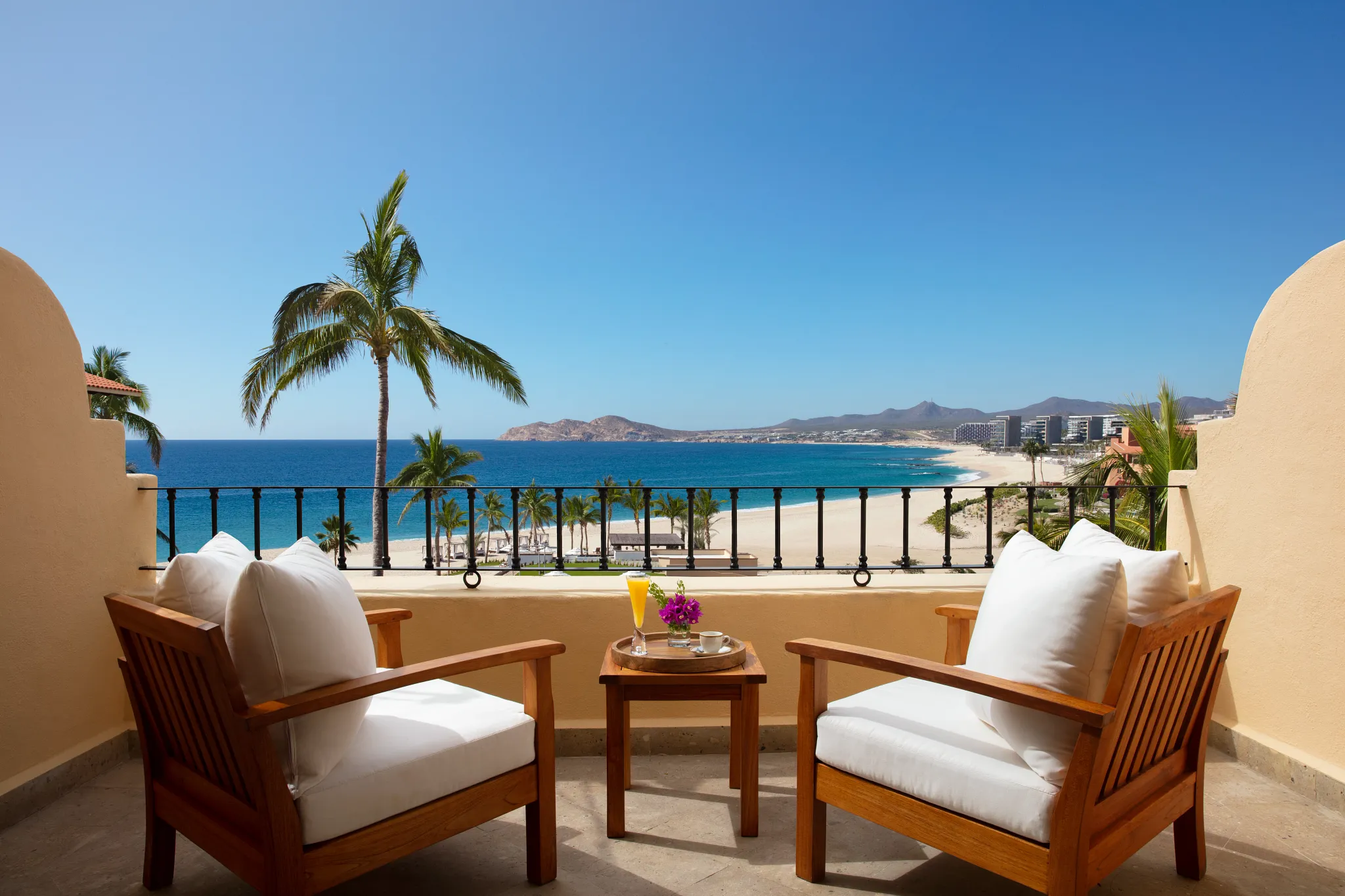 Balcony with chairs and ocean view from Junior Suite at Zoëtry Casa del Mar Los Cabos.