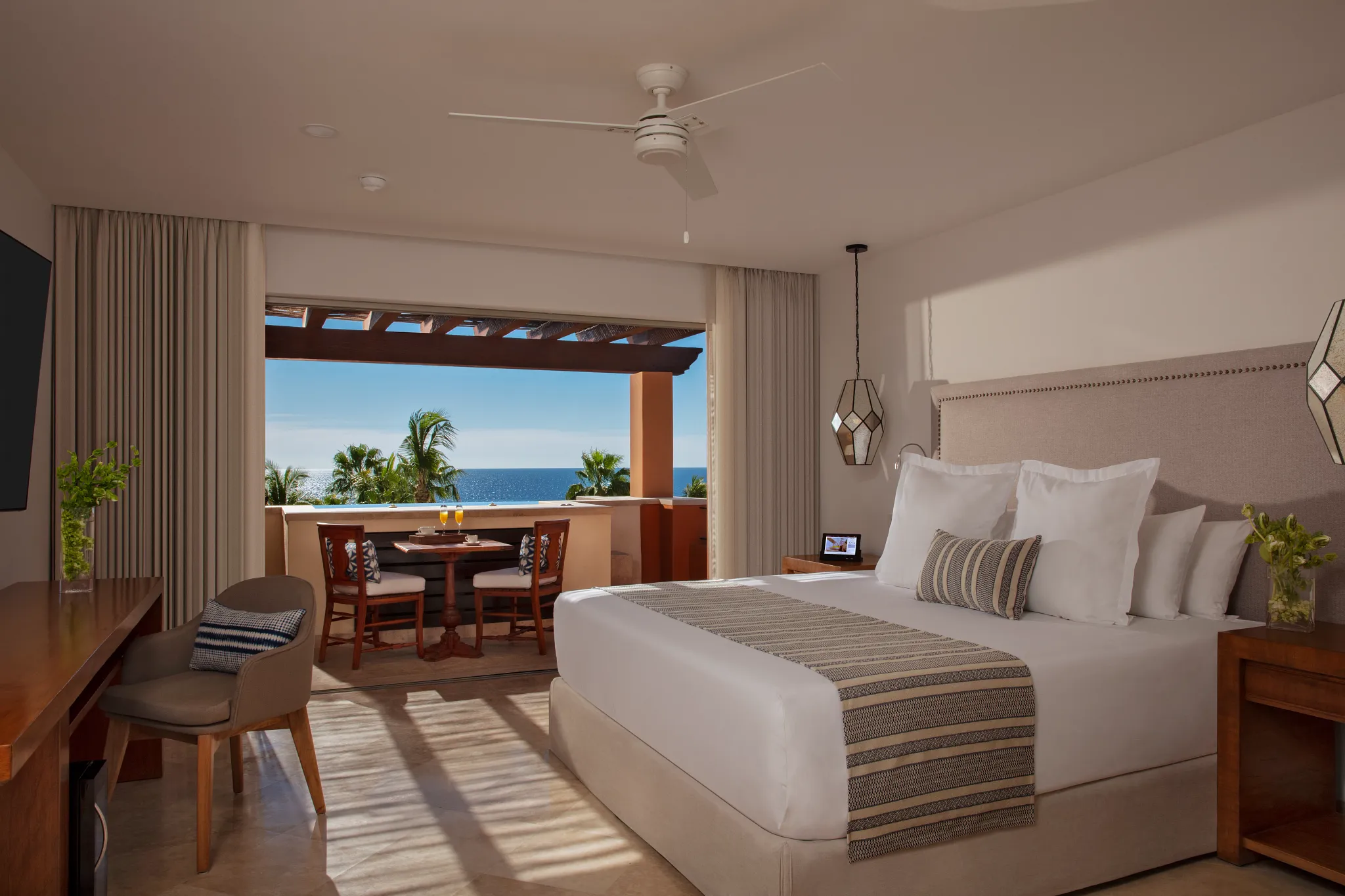 Romance Suite ocean view bedroom with king bed and private balcony at Zoëtry Casa del Mar Los Cabos.